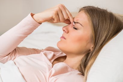 Woman waking up with headache