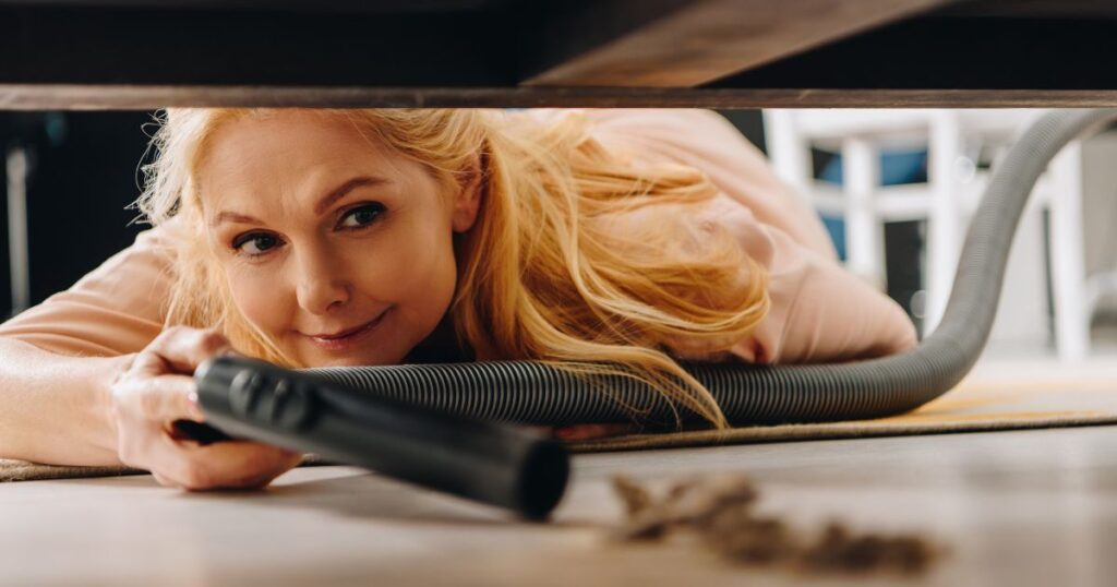 Woman easily cleaning under Futon