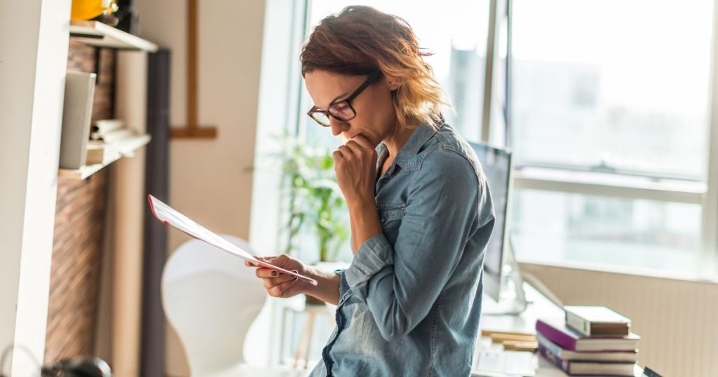 Woman reading the fine print of her bed guarantee.
