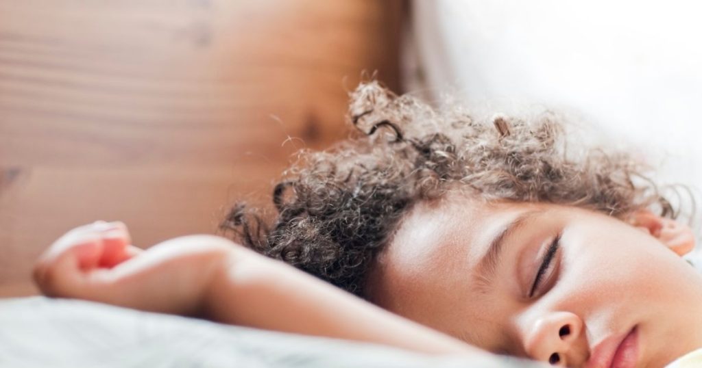 Toddler sleeping peacefully on an organic latex mattress.