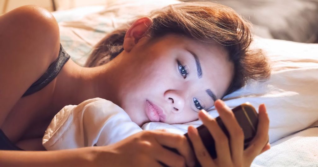 Woman reading online guest house reviews on her phone.