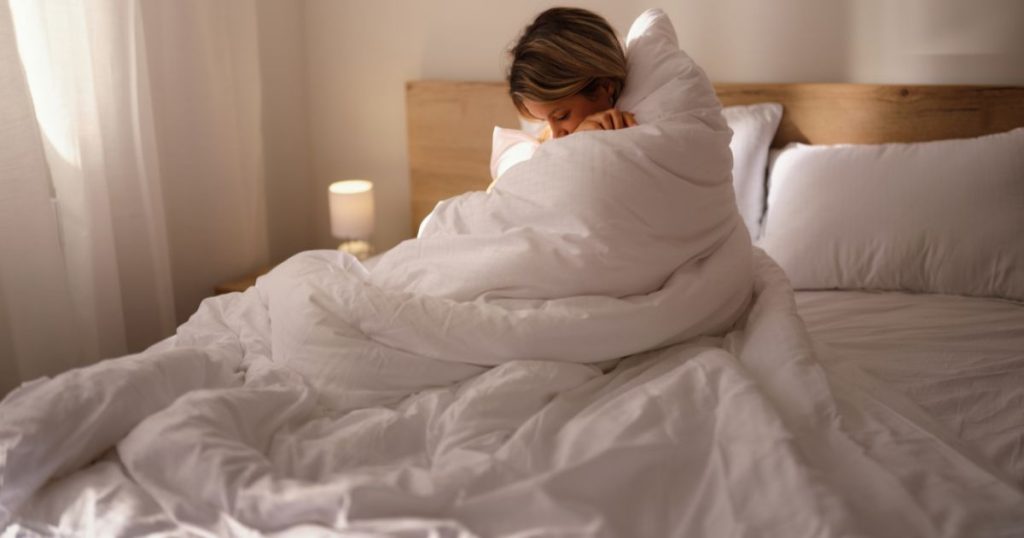 Woman wrapped up in her duvet inner.