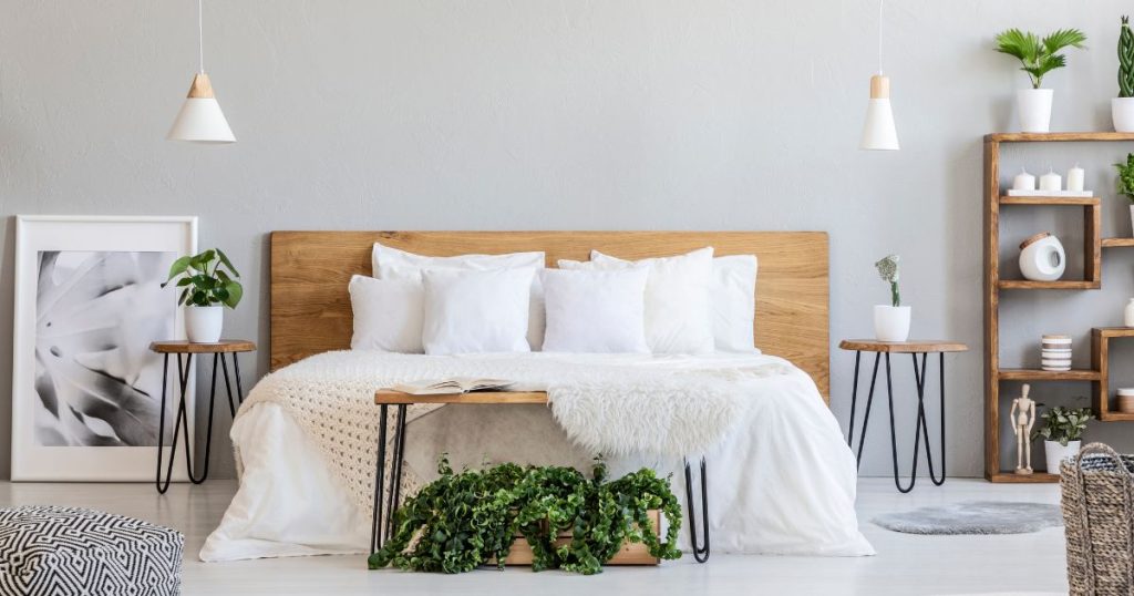 Bedroom with latex mattress, wooden furniture, and a variety of green plants