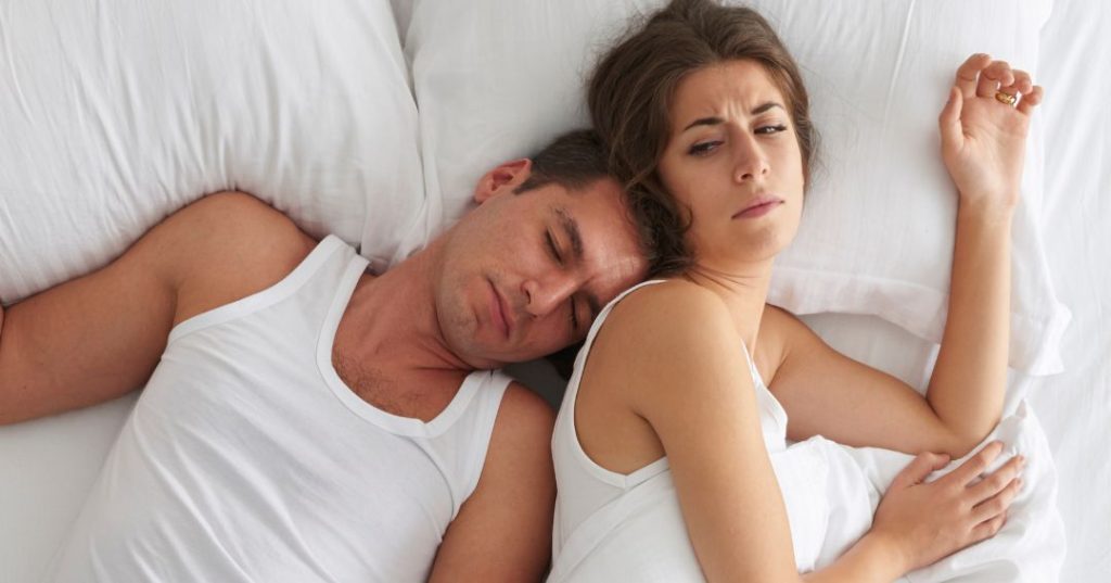 Woman annoyed at husband sleeping on her side of the bed